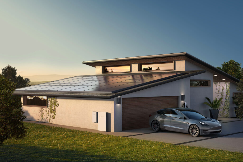 Tesla Powerwall, Wall Connector and Solar panels on a modern home with Tesla electric vehicle in the driveway.