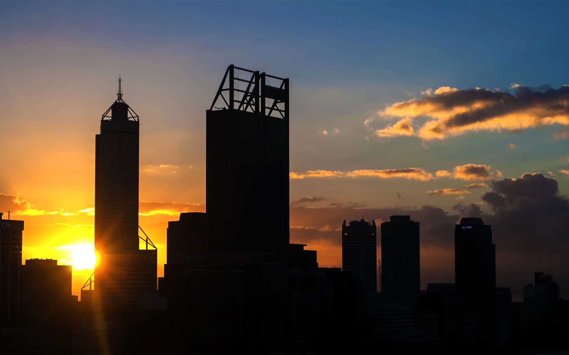 City of Perth silhouette at sunrise with sunburst on the horizon for the post Best Solar Deals in Perth WA