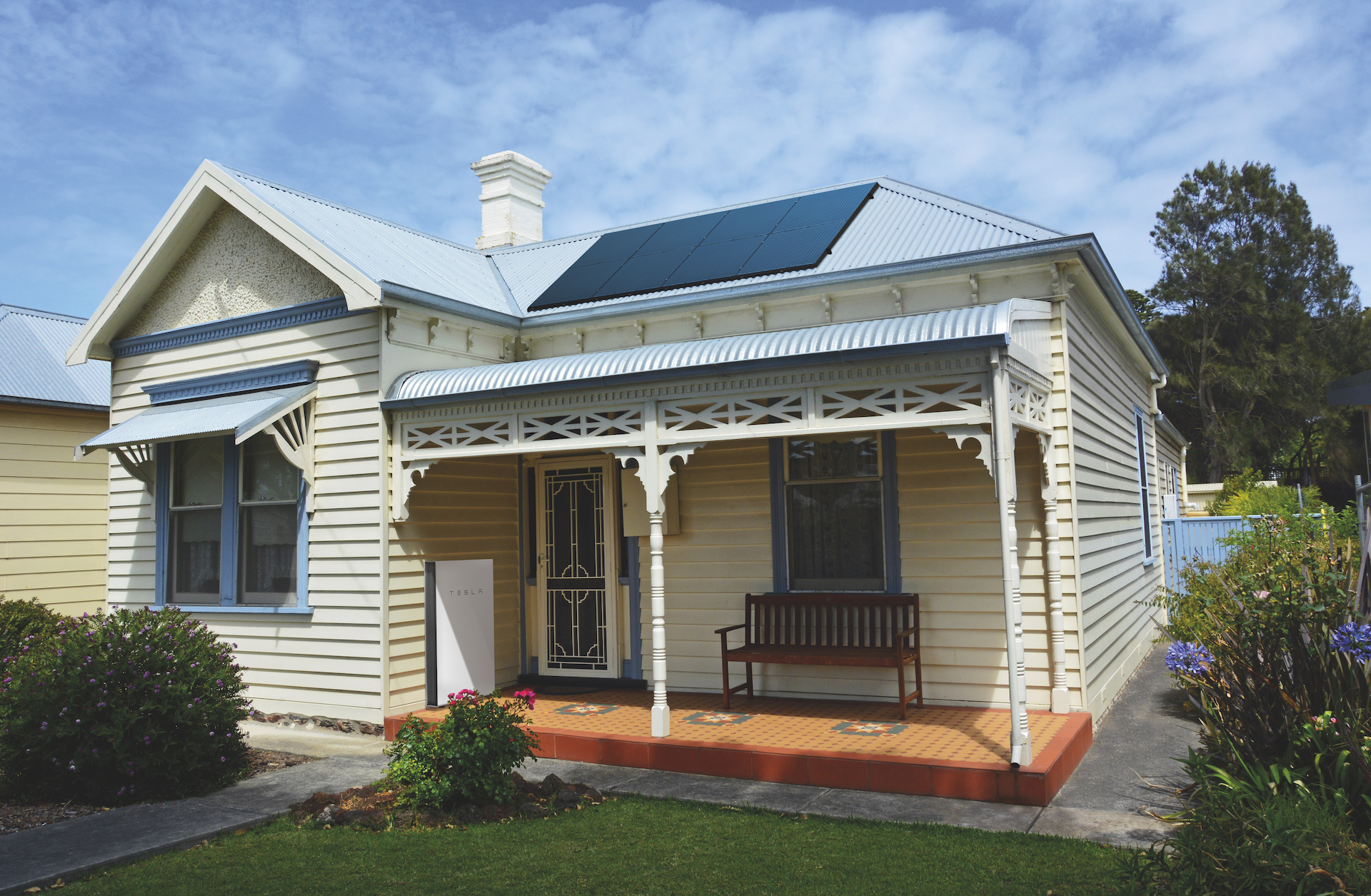 Historical cottage in Australia with solar panels on the roof and Tesla powerwall at the entry for the post Sharp advice before buying solar or batteries for your home.